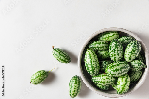 Cucamelon, Melothria scabra or mousemelon freshly harvested in a bowl on white background. top view photo