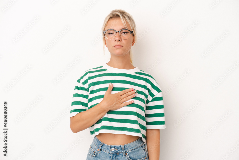 Young Russian woman isolated on white background taking an oath, putting hand on chest. Young Russian woman isolated on white background taking an oath, putting hand on chest.