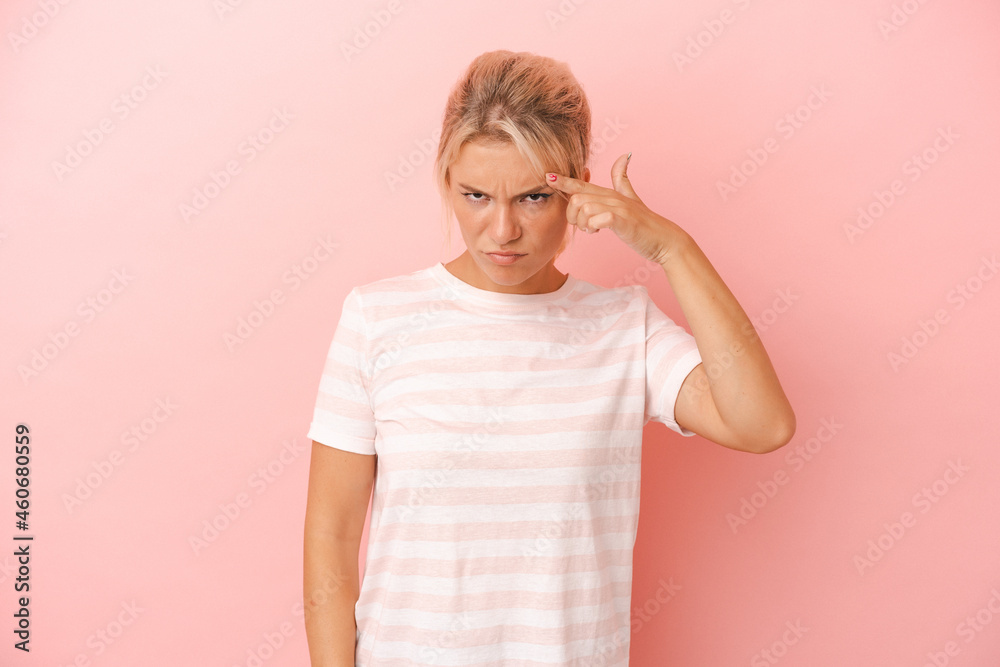 Young Russian woman isolated on pink background pointing temple with finger, thinking, focused on a task. Young Russian woman isolated on pink background pointing temple with finger, thinking, focused on a task.