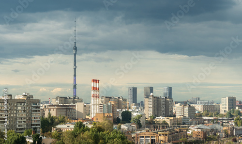 Ostankino Tower above Moscow cityscape in summer, Russia. Panorama of Moscow and TV tower on blue sky background. Moscow city skyline with Panoramic view of Moscow residential district photo