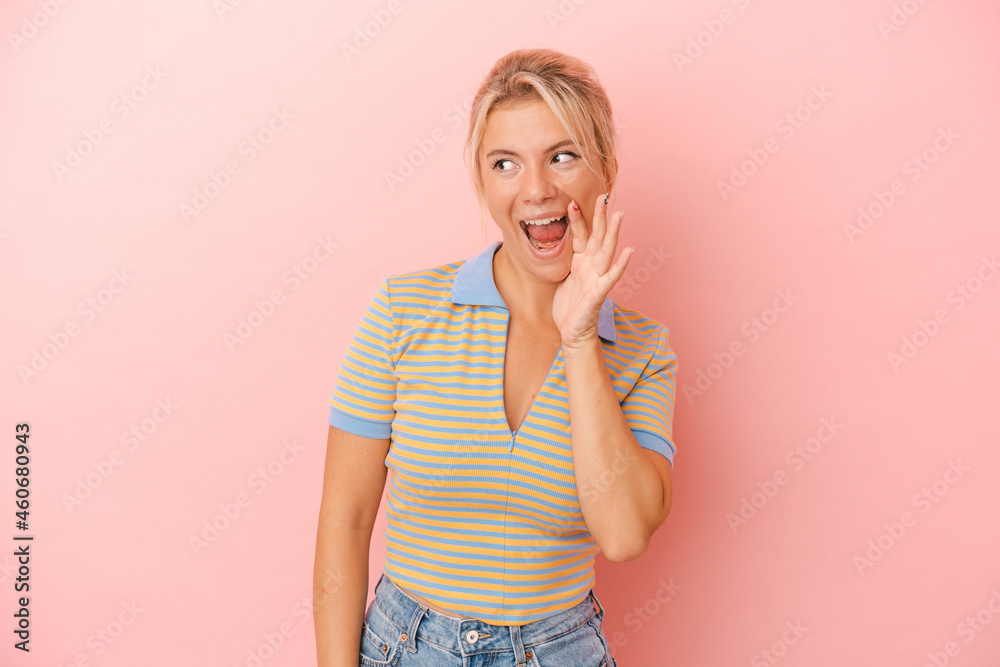 Young Russian woman isolated on pink background shouting excited to front. Young Russian woman isolated on pink background shouting excited to front.