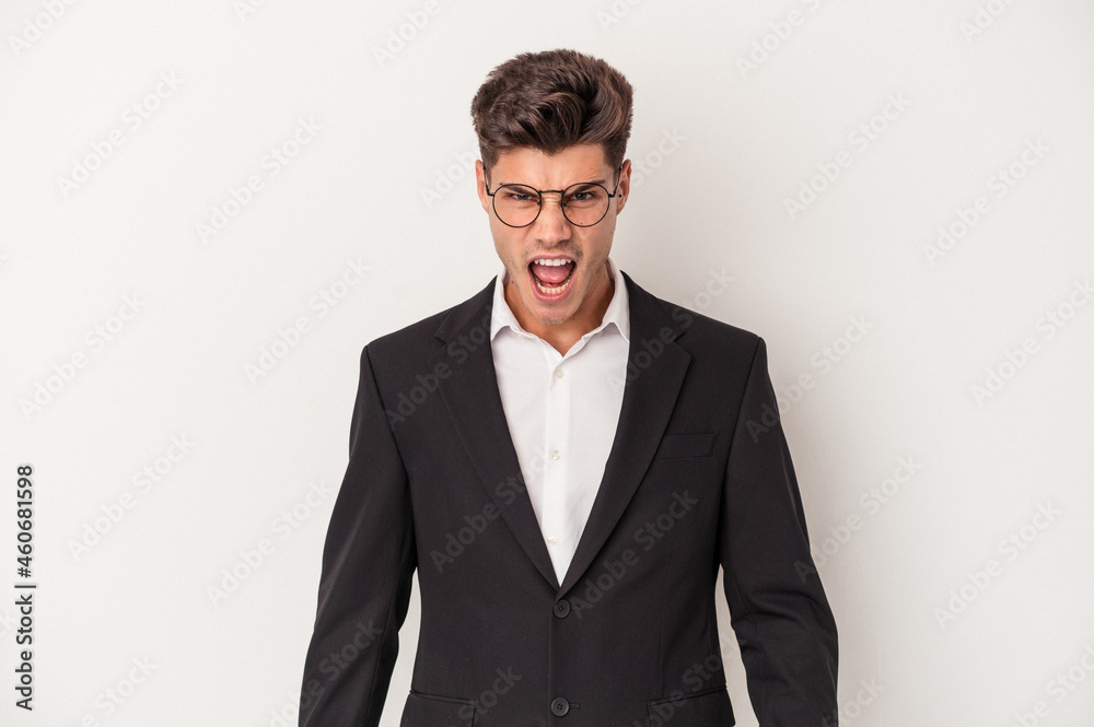 Young business caucasian man isolated on white background screaming very angry and aggressive. Young business caucasian man isolated on white background screaming very angry and aggressive.
