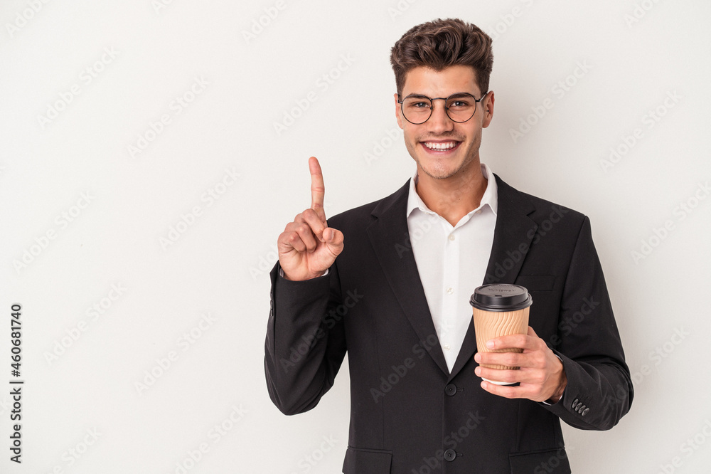 Young business caucasian man holding take away coffee isolated on white background showing number one with finger.
