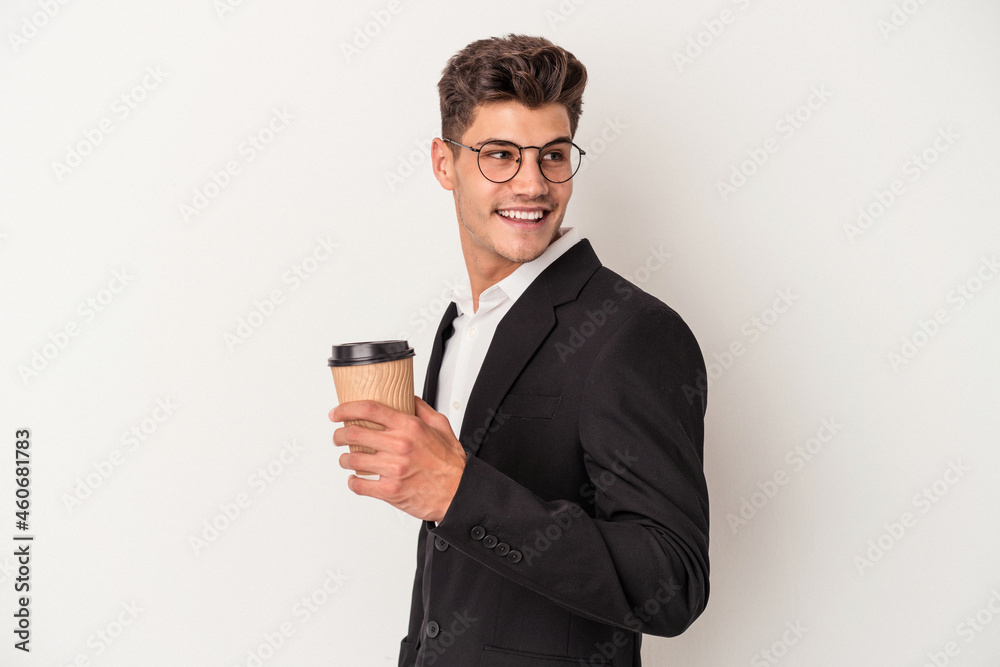 Young business caucasian man holding take away coffee isolated on white background looks aside smiling, cheerful and pleasant. Young business caucasian man holding take away coffee isolated on white background looks aside smiling, cheerful and pleasant.