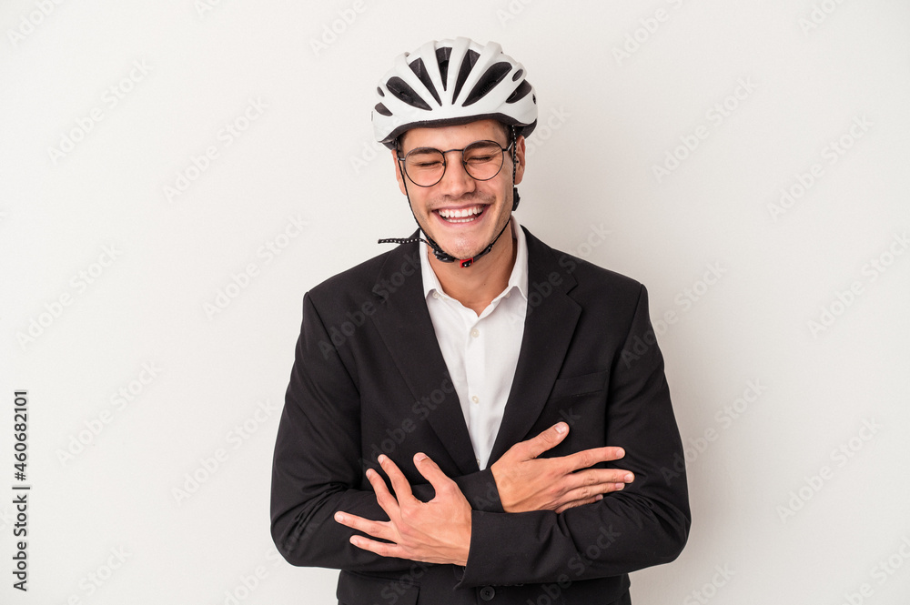 Young business caucasian man holding bike helmet isolated on white background laughing and having fun.