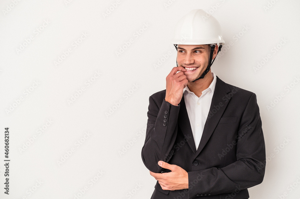 Young architect caucasian man isolated on white background relaxed thinking about something looking at a copy space. Young architect caucasian man isolated on white background relaxed thinking about something looking at a copy space.