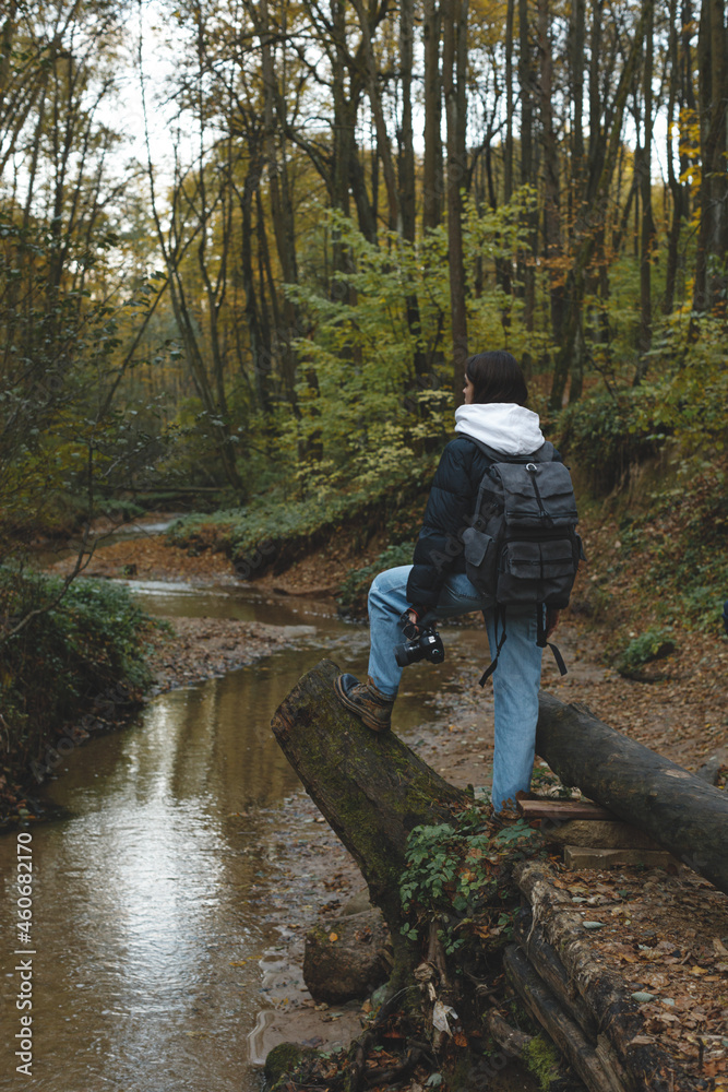 female photographer travel in autumn gloomy forest with photo camera female photographer travel in autumn gloomy forest with photo camera