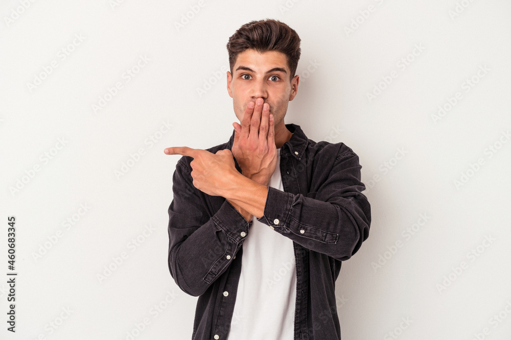 Young caucasian man isolated on white background pointing to the side Young caucasian man isolated on white background pointing to the side