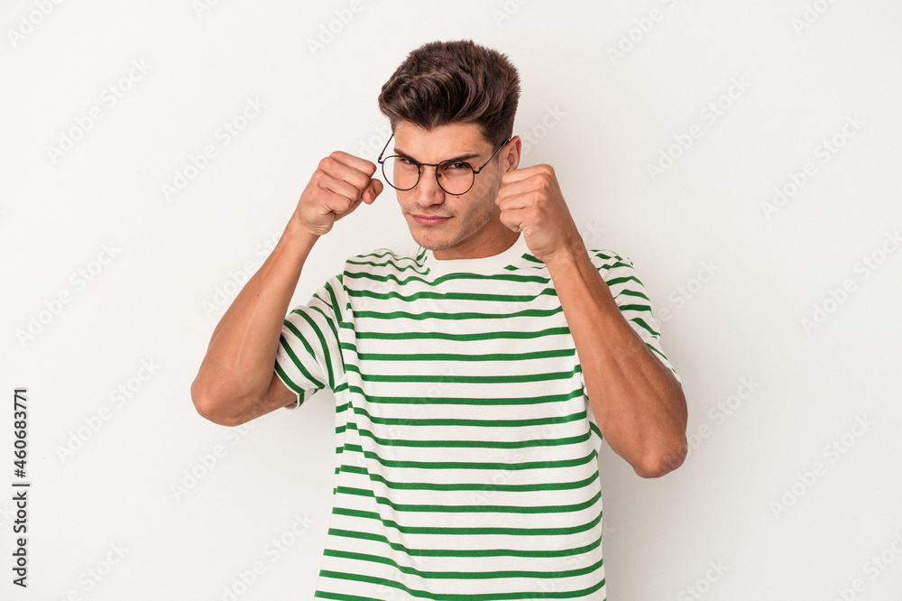 Young caucasian man isolated on white background throwing a punch, anger, fighting due to an argument, boxing. Young caucasian man isolated on white background throwing a punch, anger, fighting due to an argument, boxing.