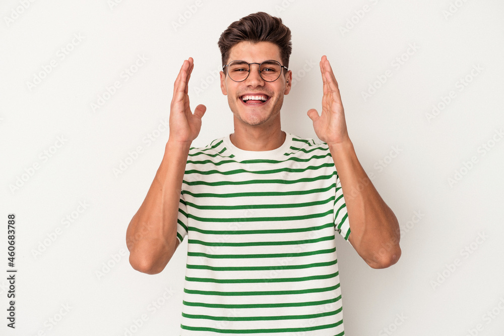 Young caucasian man isolated on white background showing a mobile phone call gesture with fingers. Young caucasian man isolated on white background showing a mobile phone call gesture with fingers.