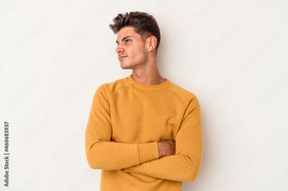 Young caucasian man isolated on white background dreaming of achieving goals and purposes