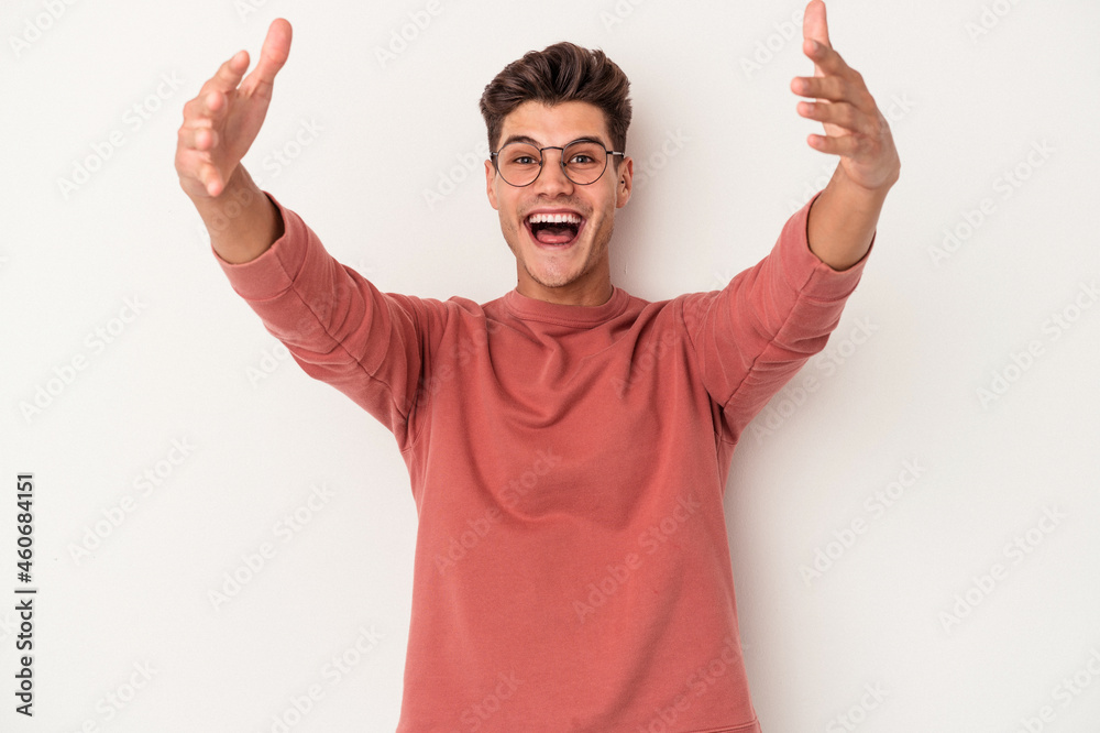 Young caucasian man isolated on white background celebrating a victory or success, he is surprised and shocked. Young caucasian man isolated on white background celebrating a victory or success, he is surprised and shocked.