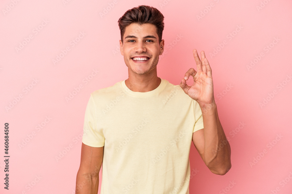 Young caucasian man isolated on pink background cheerful and confident showing ok gesture. Young caucasian man isolated on pink background cheerful and confident showing ok gesture.