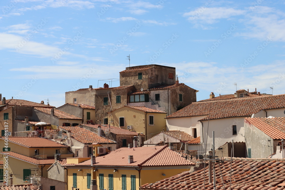 Elba, Italy – September 02, 2021: beautiful places from Elba Island. Aerial  view to the island. Little famous villages near the beaches. Summer tourist places. Clouds and blue sky in the background.