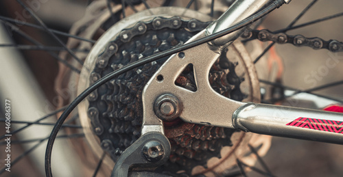 Bicycle elements in close-up. Individual parts of a sports bike are in focus. The vehicle parts are covered with dust © Alexandr