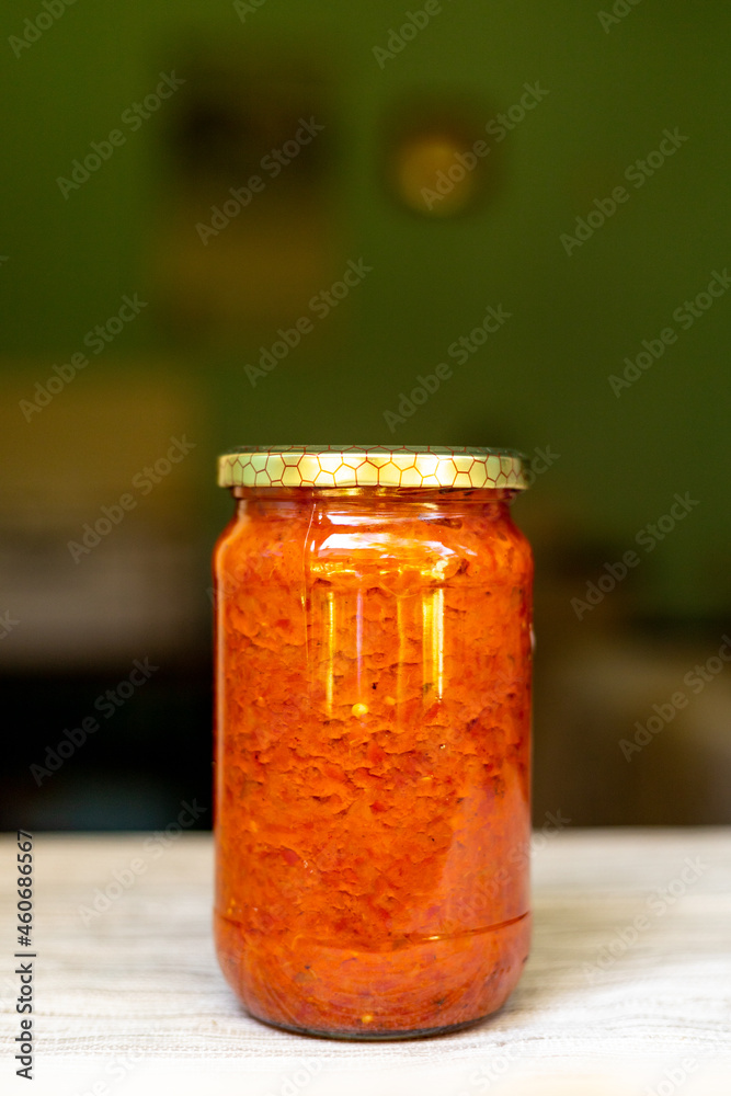 Close-up of ajvar in a glass jar. Traditional Serbian cuisine Close-up of ajvar in a glass jar. Traditional Serbian cuisine