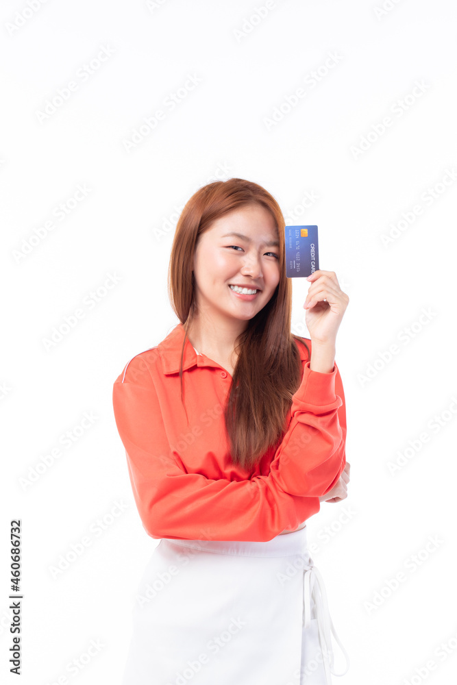 Cheerful young Asian woman in red T-shirt holding bank card isolated on white background. Cheerful young Asian woman in red T-shirt holding bank card isolated on white background.