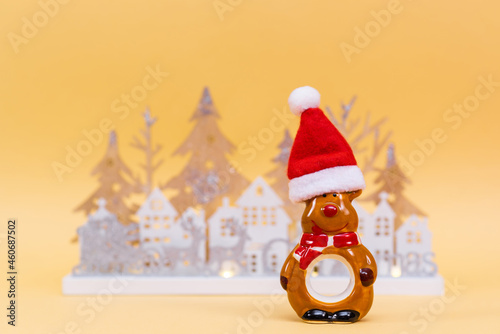 Merry Christmas and Happy Holidays. Christmas reindeer in santa hat on yellow background