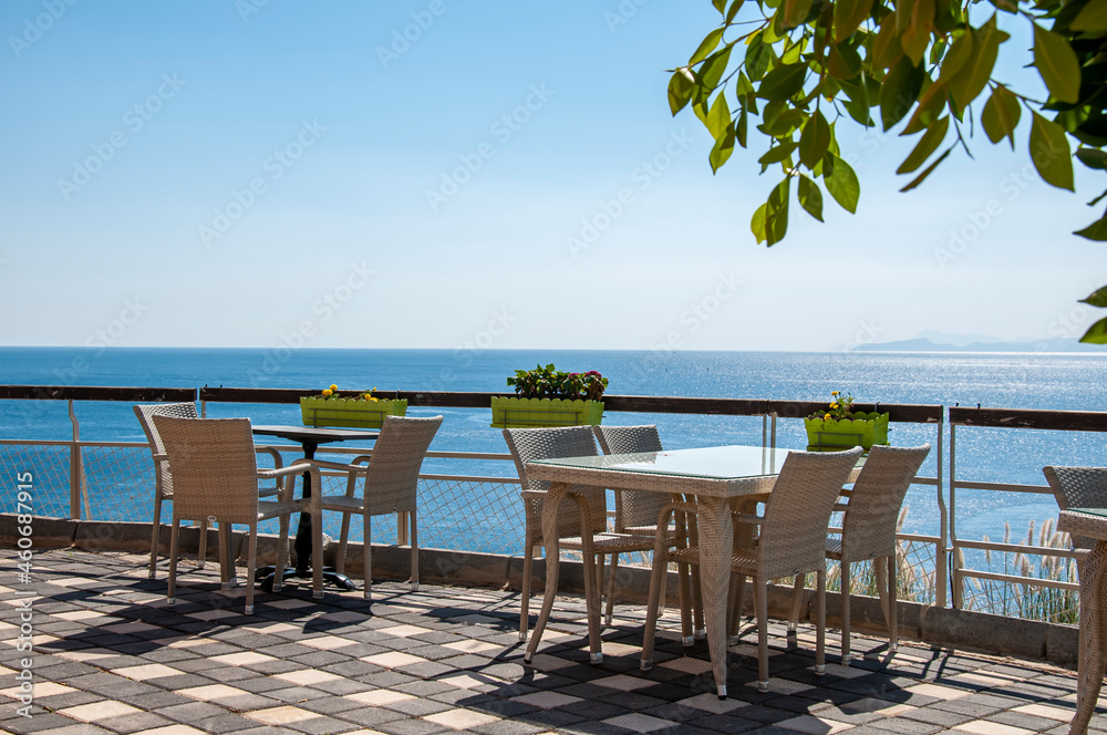 Tables and chairs of the restaurant by the beach.