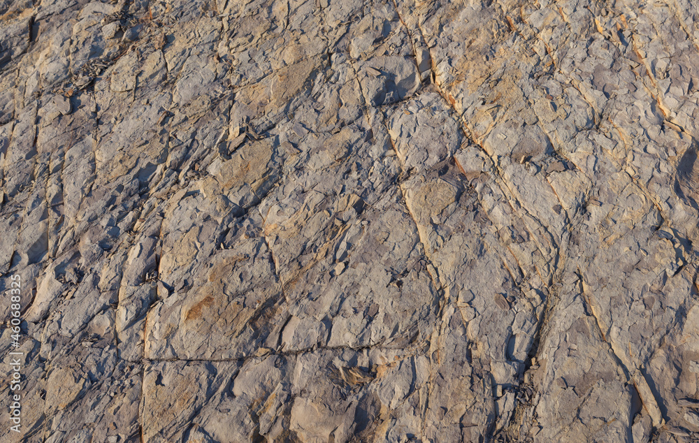Texture, background layers and cracks in sedimentary rock on cliff face. Rock slate in the mountain. Seamless abstract background. Cracks and layers of sandstone. Texture, background layers and cracks in sedimentary rock on cliff face. Rock slate in the mountain. Seamless abstract background. Cracks and layers of sandstone.