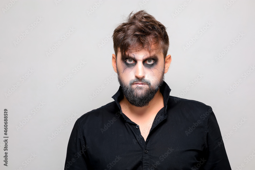 bearded men with makeup for Halloween looks at the camera bearded men with makeup for Halloween looks at the camera