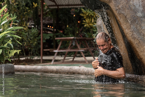 elderly latin man enjoying a natural hot spring pool 