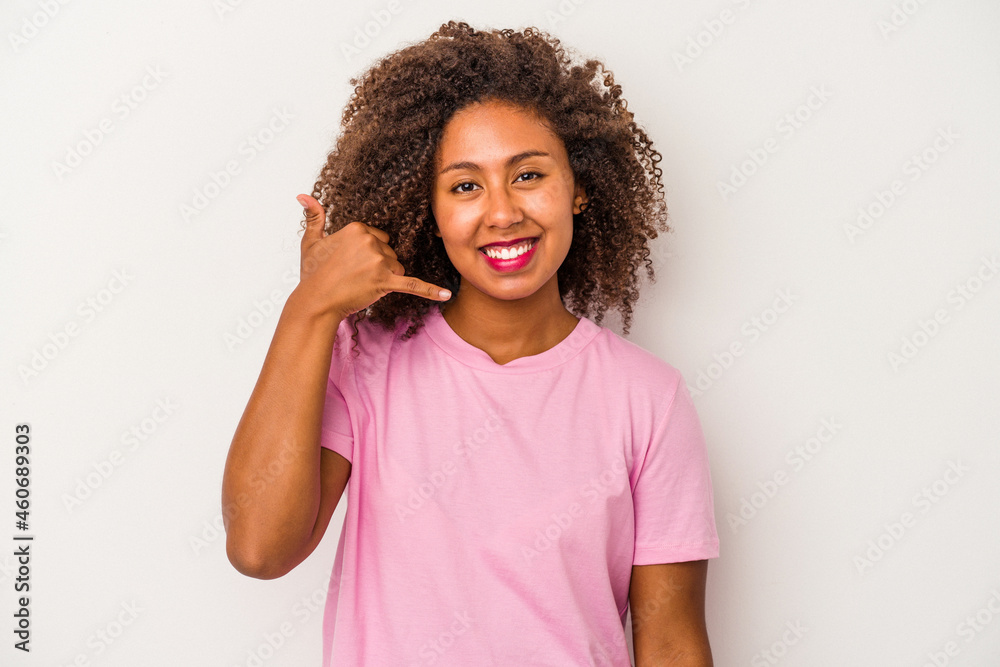 Young african american woman with curly hair isolated on white background showing a mobile phone call gesture with fingers.