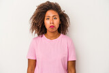 Young african american woman with curly hair isolated on white background sad, serious face, feeling miserable and displeased.