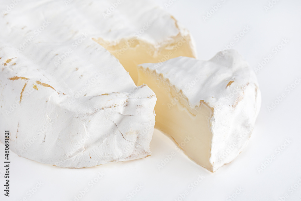 Camembert on a white background. Camembert cheese close-up on a white background. Camembert on a white background. Camembert cheese close-up on a white background.