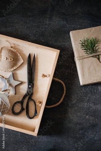 Zero waste, Sustainable, green, eco-friendly Christmas gifts. Zero Waste Gift Wrapping flat lay. Craft paper gift box, twine and scissors on wooden table