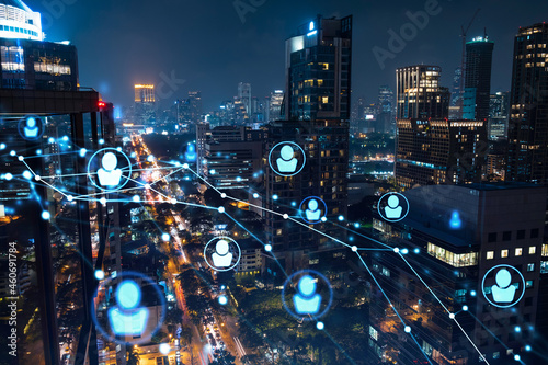 Glowing social media icons on night panoramic city view of Bangkok, Southeast Asia. The concept of networking and establishing new connections between people in businesses. Double exposure.