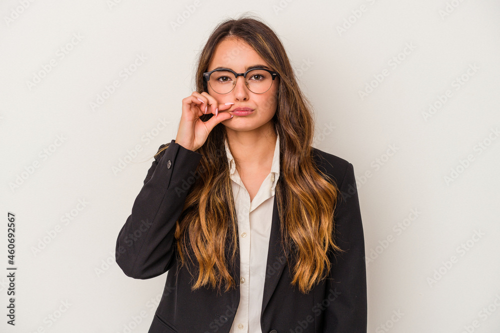 Young caucasian business woman isolated on white background with fingers on lips keeping a secret. Young caucasian business woman isolated on white background with fingers on lips keeping a secret.