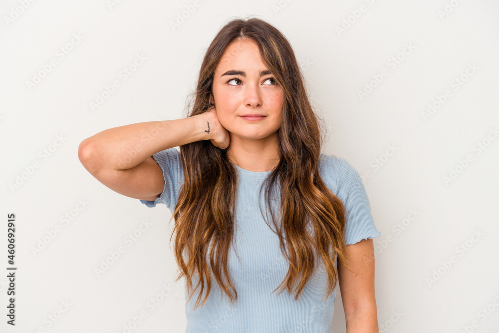 Young caucasian woman isolated on white background touching back of head, thinking and making a choice. Young caucasian woman isolated on white background touching back of head, thinking and making a choice.