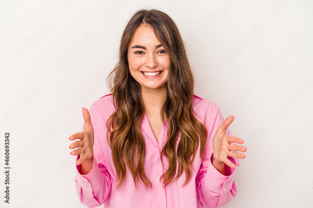 Young caucasian woman isolated on white background holding something with both hands, product presentation. Young caucasian woman isolated on white background holding something with both hands, product presentation.