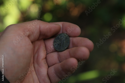 Ancient Roman coin in hand photo