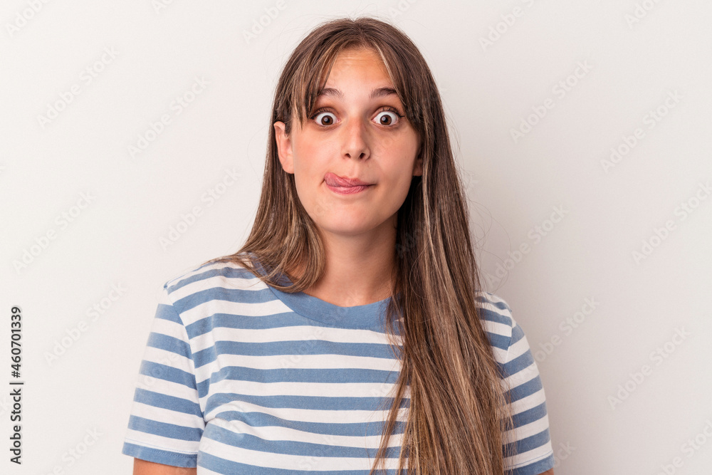 Young caucasian woman isolated on white background touches tummy, smiles gently, eating and satisfaction concept. Young caucasian woman isolated on white background touches tummy, smiles gently, eating and satisfaction concept.