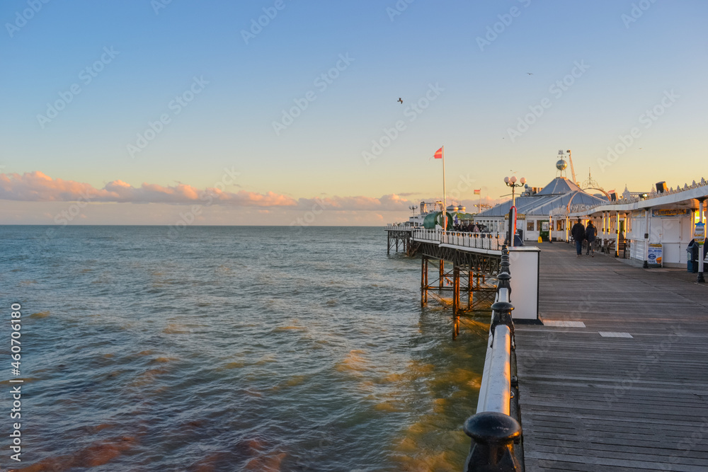 Obraz premium UK, Brighton, 01.10.2021: Brighton's big famous pier. Close up view during sunset