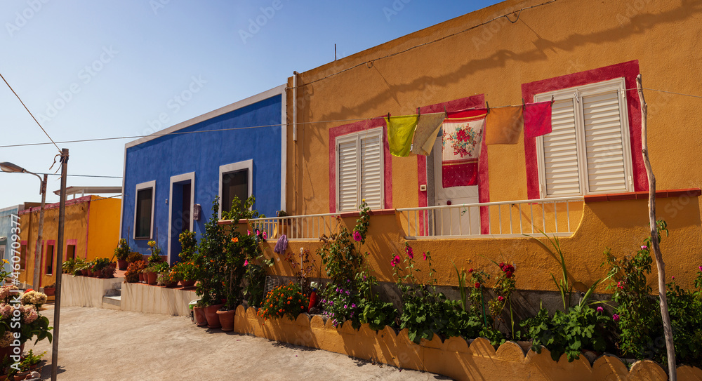 View of a typical colorful houses of Linosa, colored with blue red and orange