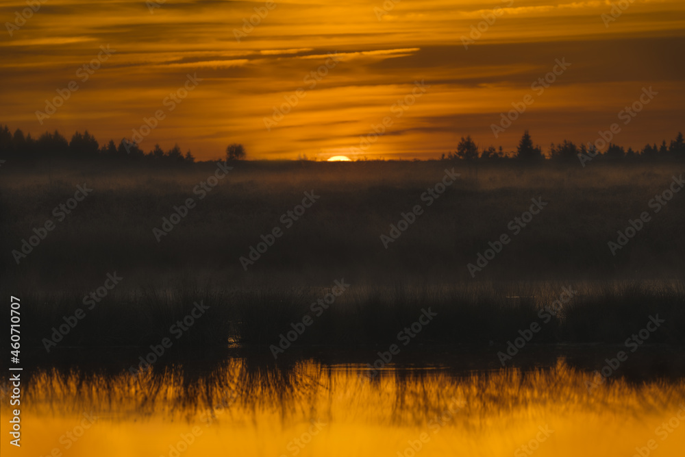 Reflections of a misty sunset