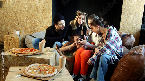 Teenagers are stuck in their phones instead of eating hot pizza