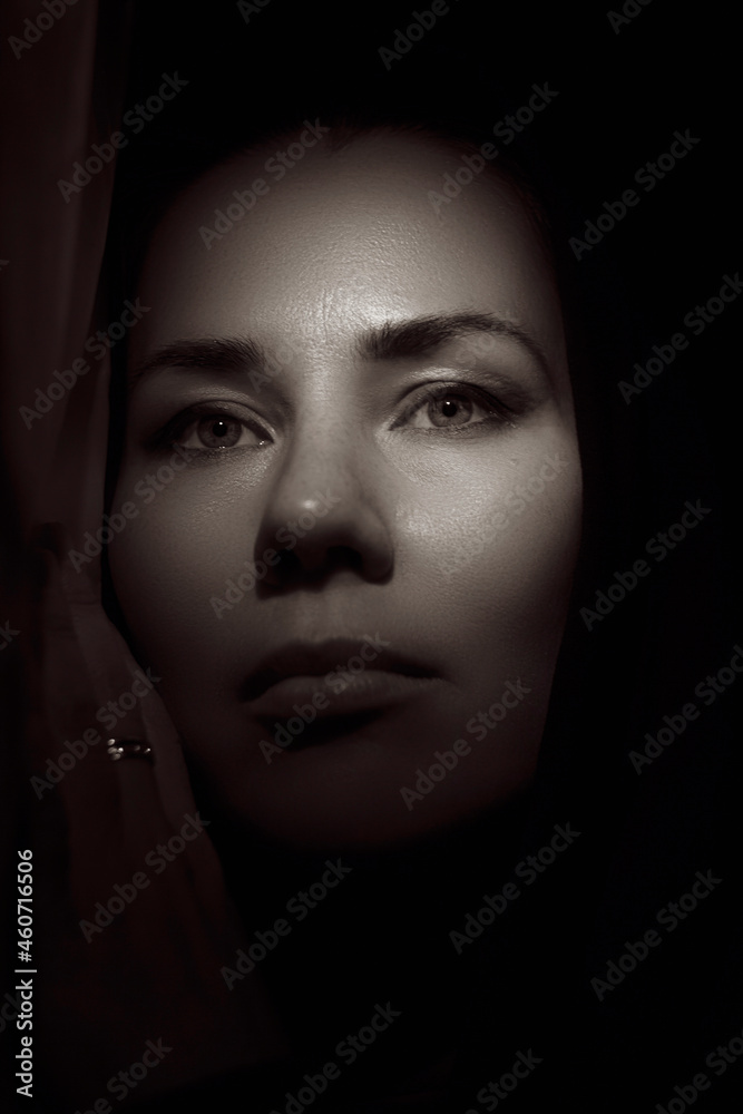 Portrait of a young woman in the shade close up