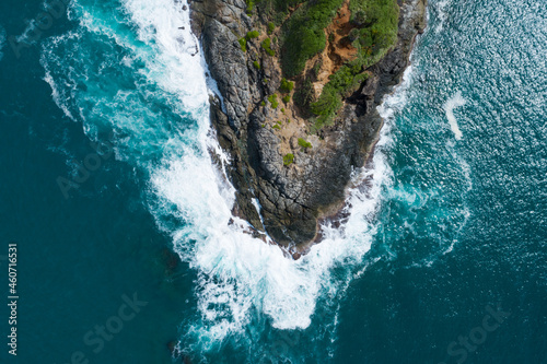 Aerial view Top down seashore big wave crashing on rock cliff Beautiful dark sea surface in sunny day summer background Amazing seascape top view seacoast at Phuket Thailand