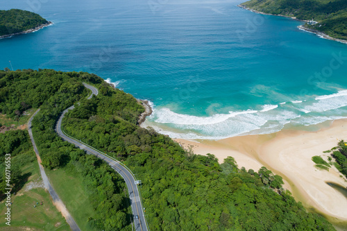 Aerial view of curve road along the Naiharn beach at Phuket Thailand beautiful sandy beach and open sea in summer season Nature recovered Environment and Travel background