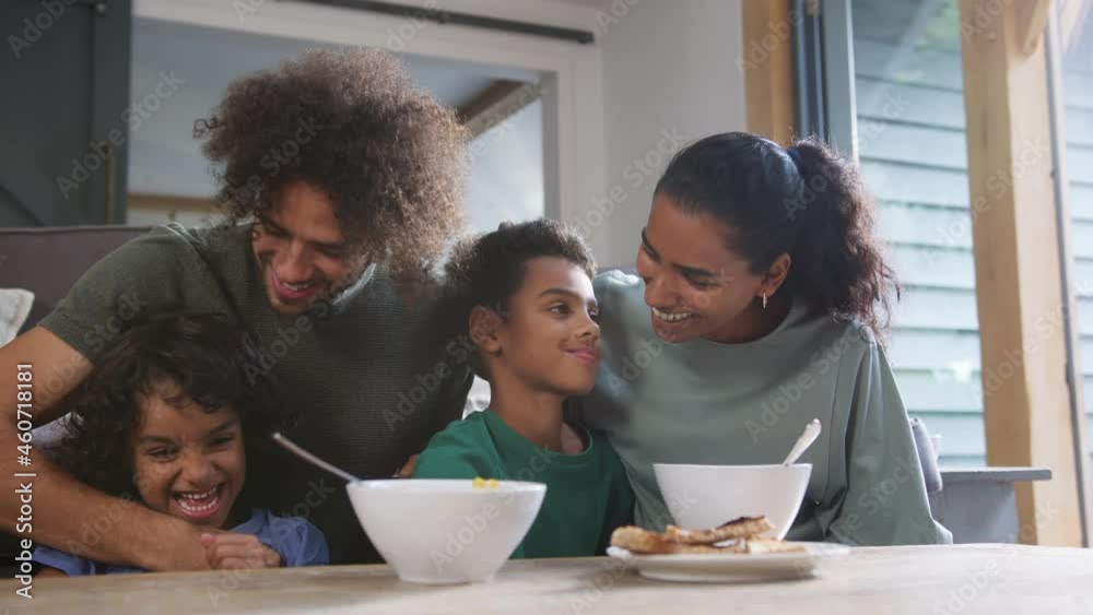 Slow motion of children eating breakfast with parents Slow motion of children eating breakfast with parents
