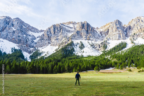 Mountain landscape with hiker and snow on the mountains. photo