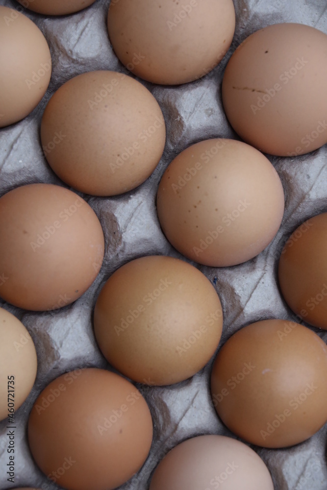 pile of chicken eggs in large quantities on a paper tray pile of chicken eggs in large quantities on a paper tray