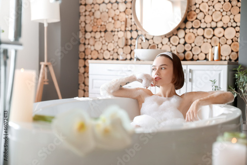 Young woman taking bath wit...