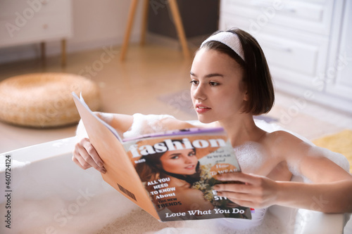 Young woman reading magazin...