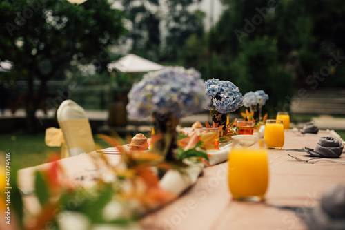 table decoration,with orange juice. selective focus and shallow depth of field. horisontal version of the photo. photo