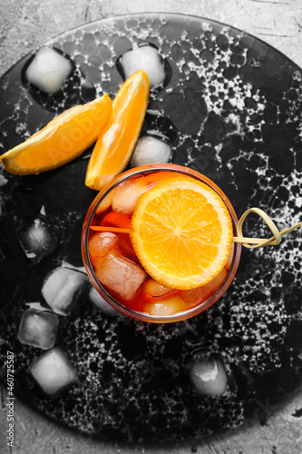 Glass of Aperol spritz cocktail on grunge background